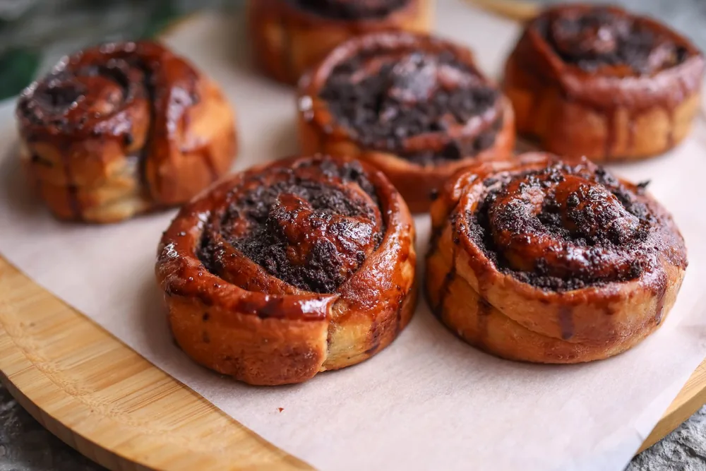 Rolled pastry products on a wooden tray