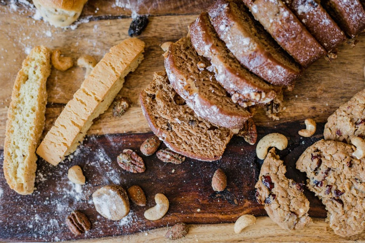 Gluten-free bread, bakery products and nuts on a wooden board